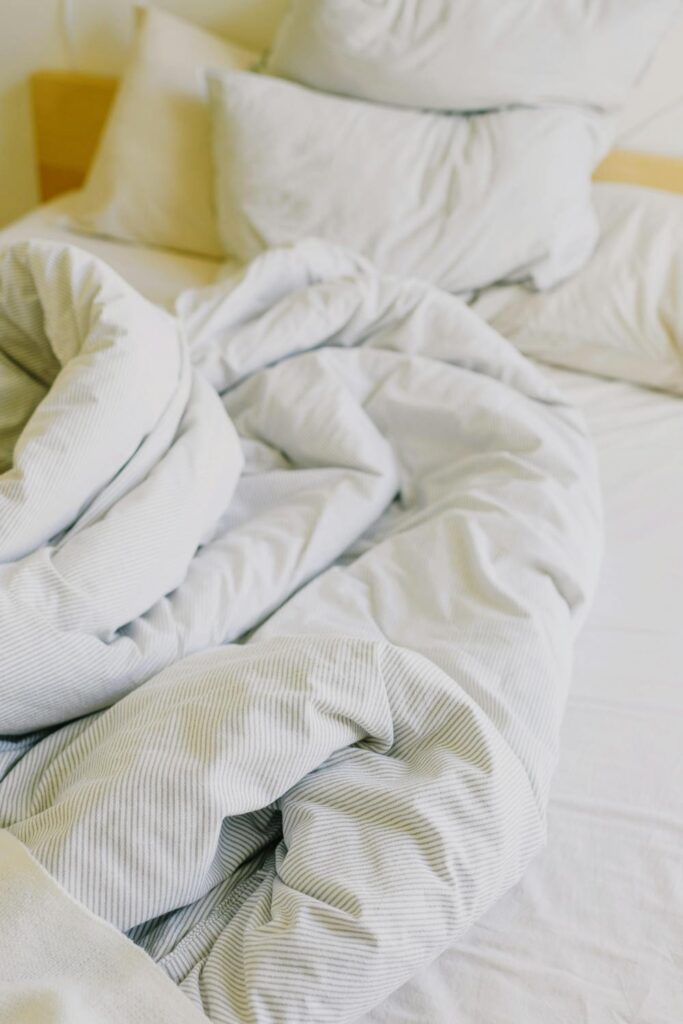 White pillows and comforter on an unmade bed