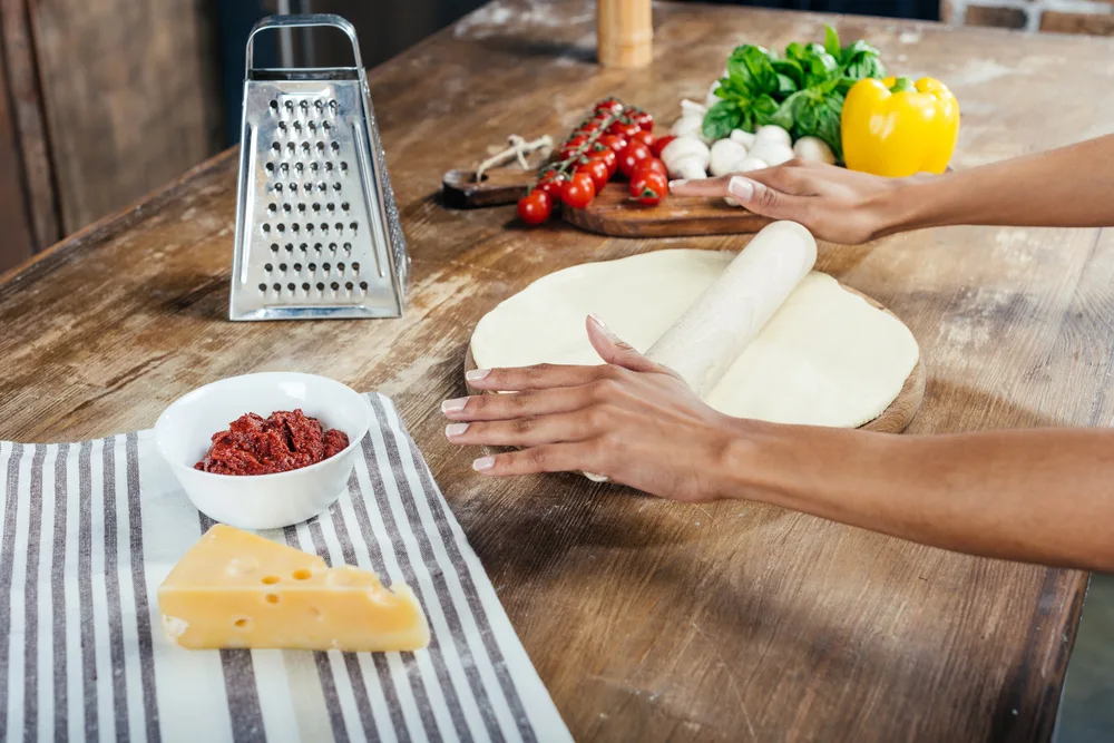 Woman rolling dough — Photo