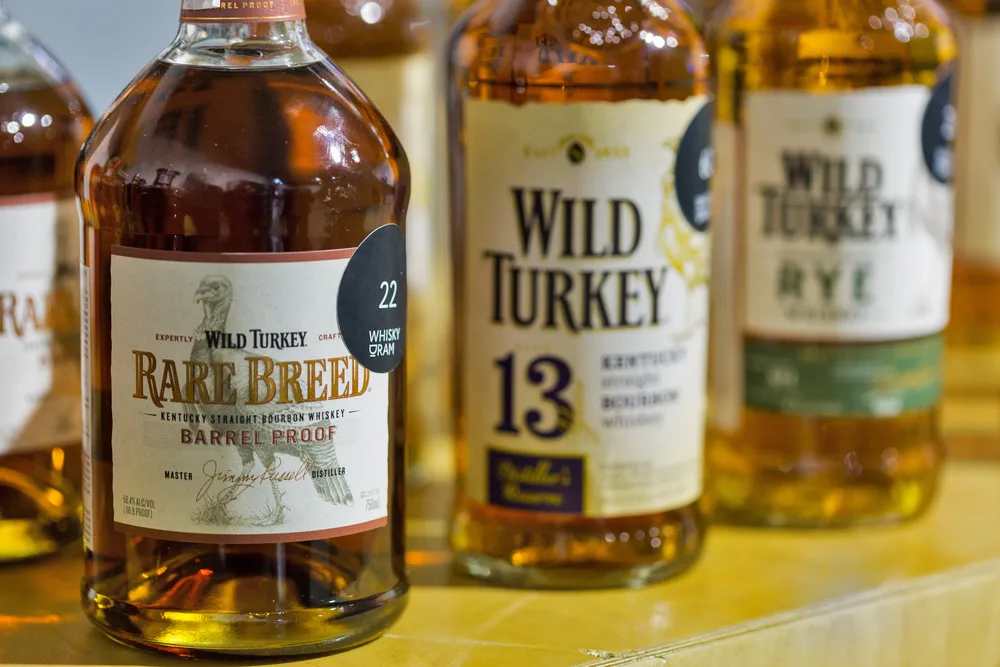 KIEV, UKRAINE - OCTOBER 20, 2018: Wild Turkey bourbon whisky bottles closeup in a row at 4th Ukrainian Whisky Dram Festival organized by Good Wine company in Artistic Arsenal. — Photo by panama7