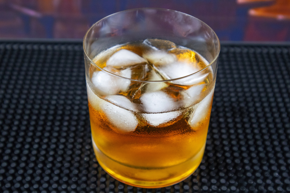 Sea breeze cocktail in glass on wooden table. Copy space