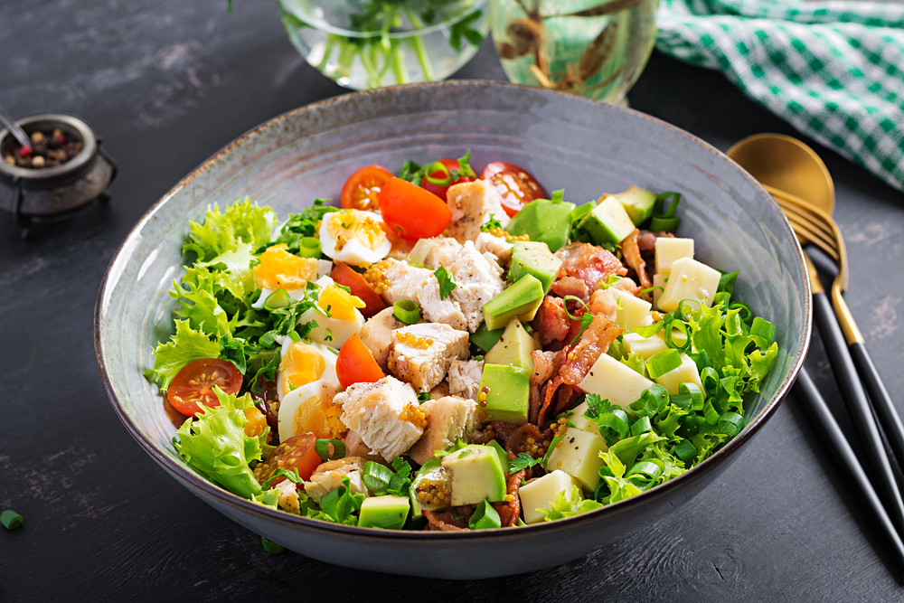 Healthy cobb salad with chicken, avocado, bacon, tomato