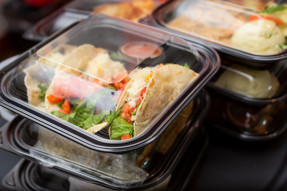 A view of several entrees prepared inside to-go plastic