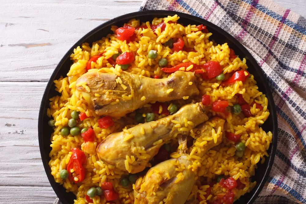 Paella with chicken and vegetables closeup.