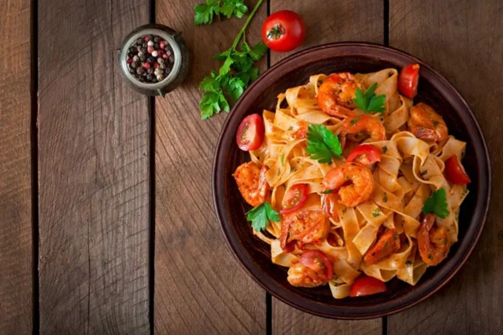Fettuccine pasta with shrimps, tomatoes and herbs. — Stock Photo, Image
