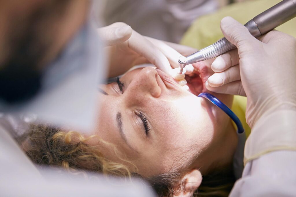 A woman getting her teeth cleaned at the dentist