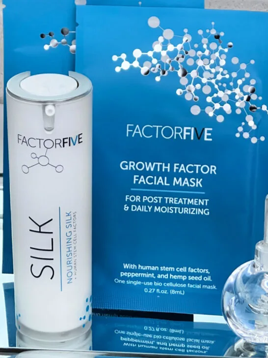 Close up of both FactorFive Skincare products on a mirrored tray with a crystal perfume bottle next to them