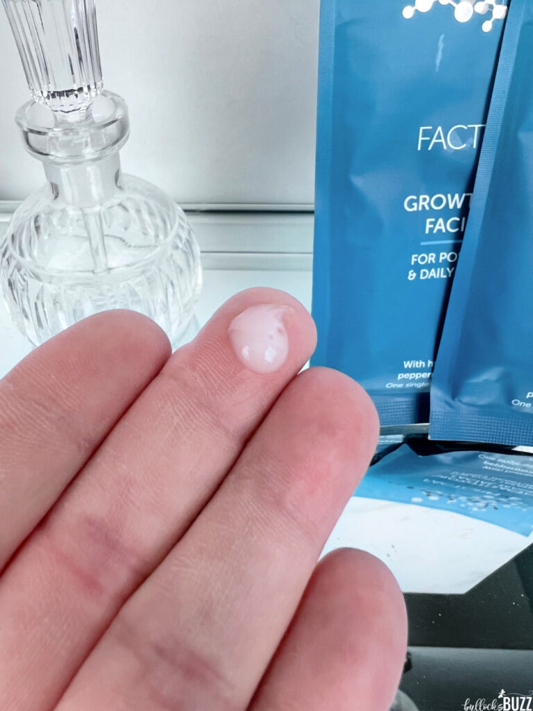 A drop of Nourishing Silk moisturizer on a fingertip
