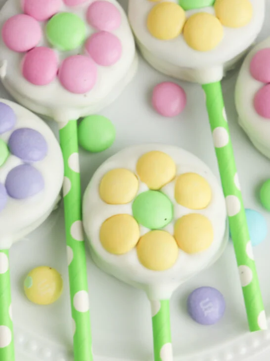 close up image of white-chocolate covered Oreo cookies with pastel M&Ms laid out to look like flowers