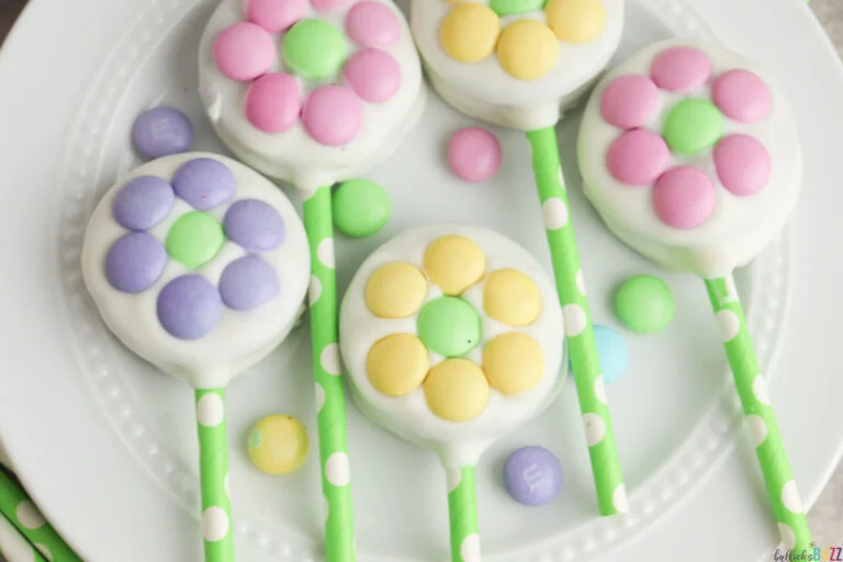close up image of white-chocolate covered Oreo cookies with pastel M&Ms laid out to look like flowers