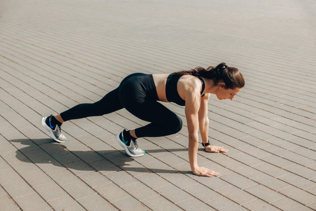 A woman in black workout clothes stretching before running. Simple exercise can help you regain and maintain your energy.