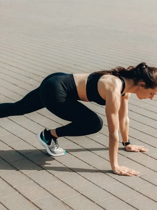 A woman in black workout clothes stretching before running. Simple exercise can help you regain and maintain your energy.