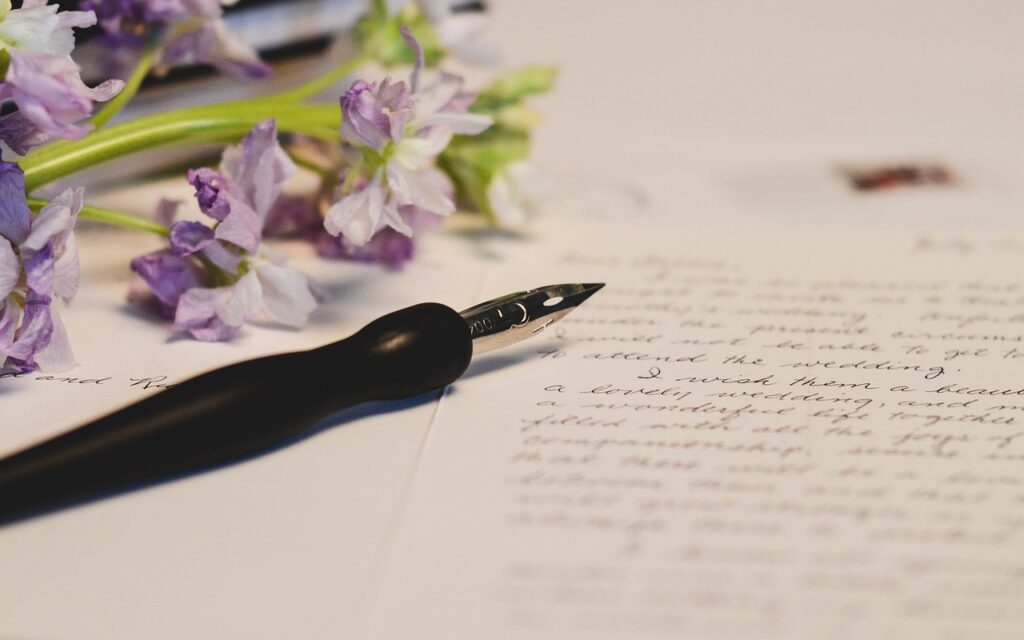 a calligraphy pen on a piece of paper with writing