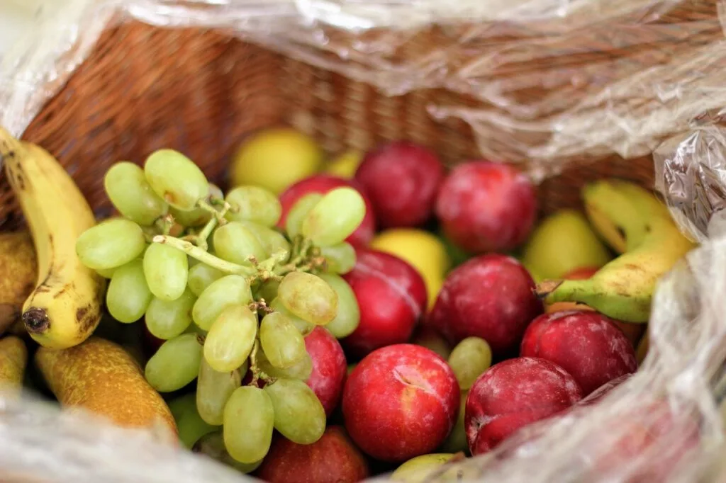 a basket full of fruits as part of purchasing fruits and vegetables in large quantities