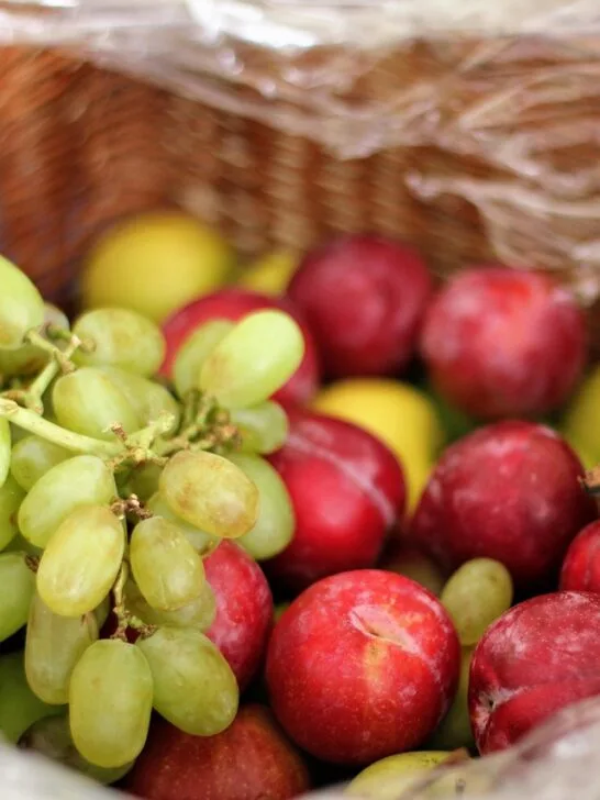 a basket full of fruits as part of purchasing fruits and vegetables in large quantities