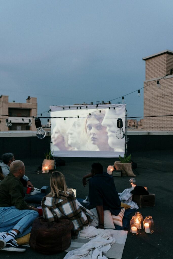 people watching a movie in their backyard