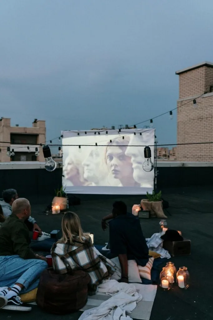 people watching a movie in their backyard