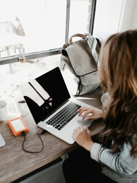 A girl working on her laptop learning about monetizing your blog.