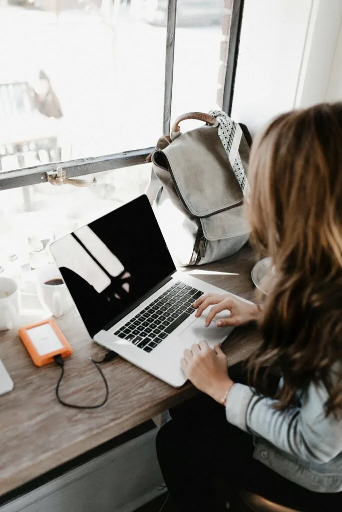 A girl working on her laptop learning about monetizing your blog.
