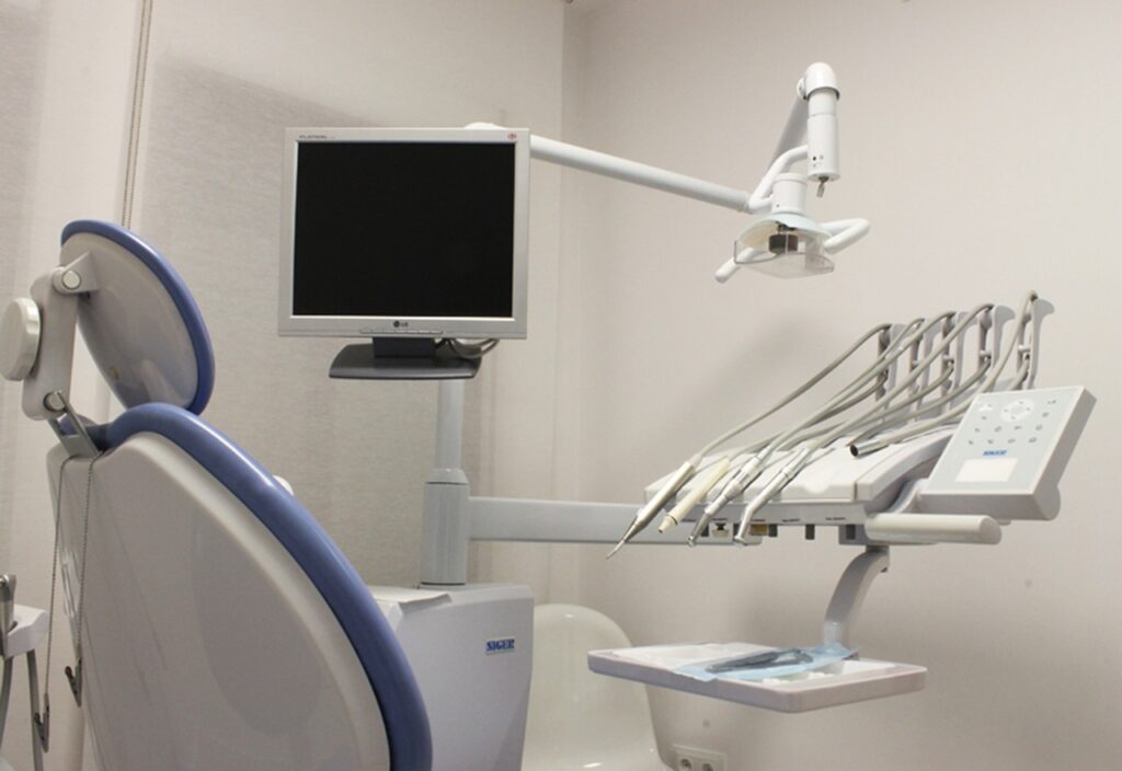 A modern dental care set up including monitor, chair. and tools