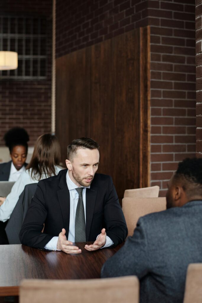 A lawyer explaining something to his client while they sit at a table