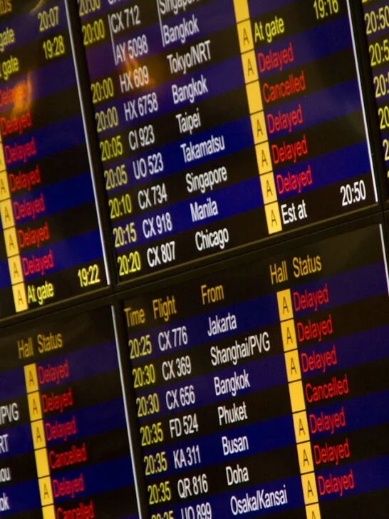 A flight board at an airport showing many flights and destinations, all part of travel planning