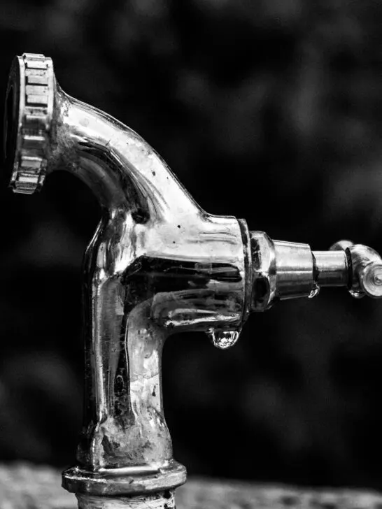 Close up of a leaking faucet. There are many ways to detect a water leak in your house to prevent damage.