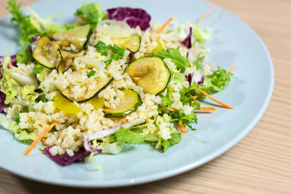 Pearl barley salad with zucchini and colorful vegetables