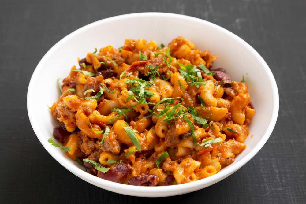 Homemade Chili Mac and Cheese with Parsley in a white bowl over — Stock Photo, Image