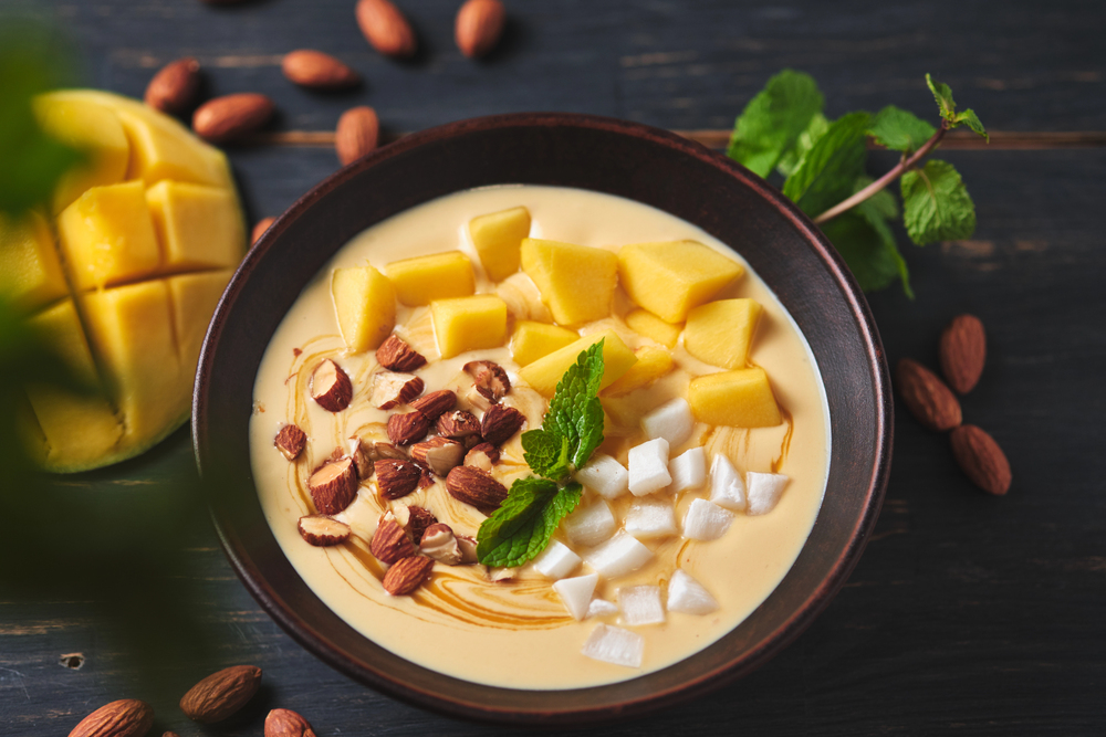 Tropical Smoothie Bowl Banana Mango Coconut Nuts Refreshing Dessert Mint — Stock Photo, Image
