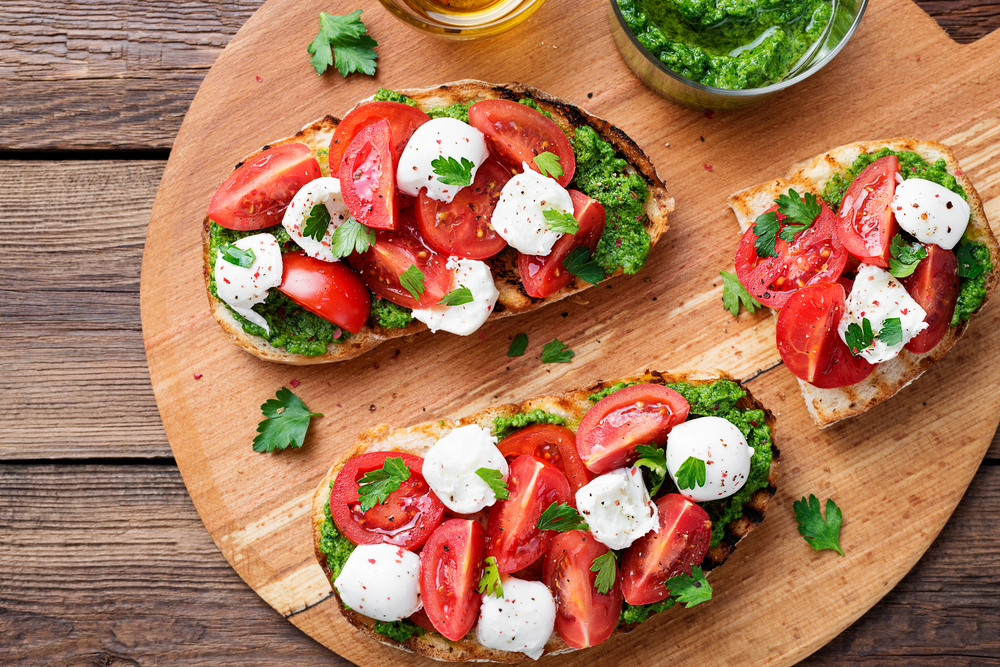 Bruschetta Cherry Tomatoes Mozzarella Cheese Pesto Sauce Wooden Board Traditional — Stock Photo, Image