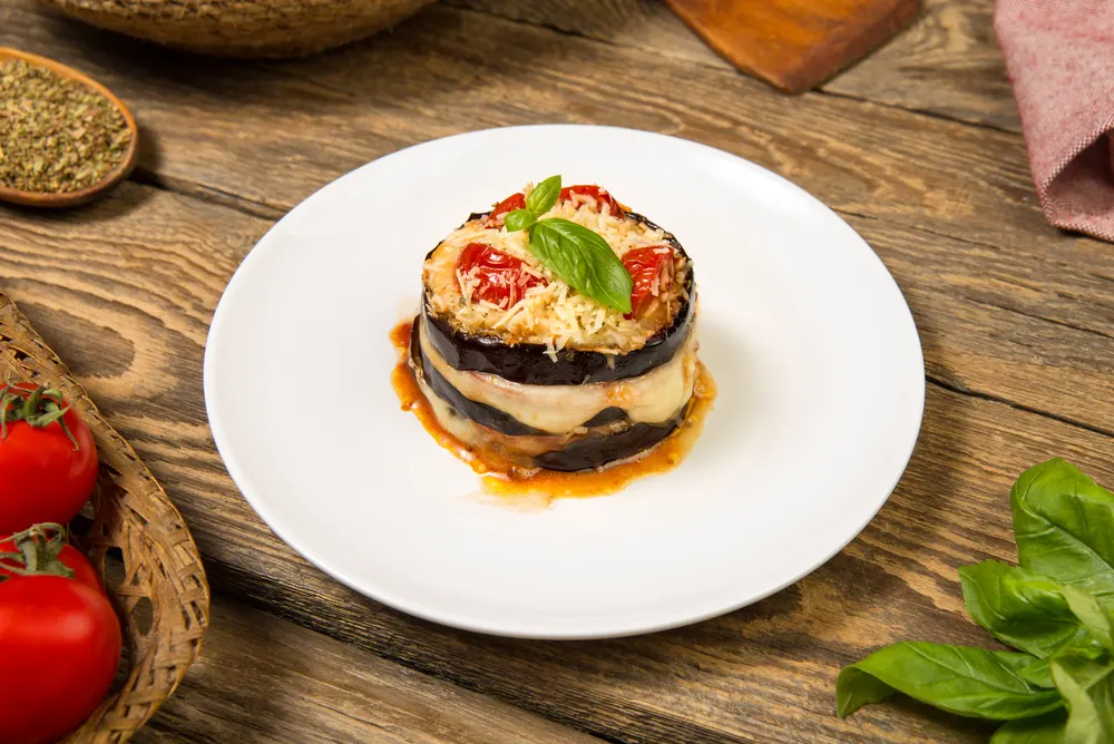 Baked eggplant and tomatoes mozzarella and parmesan stack