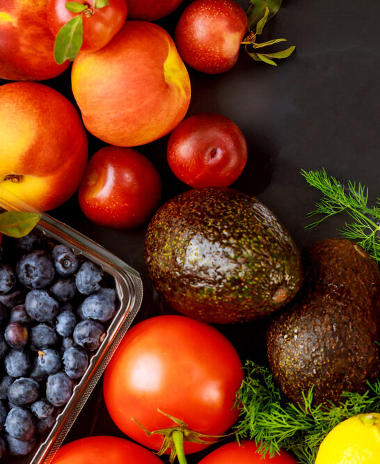 Healthy fruits and vegetable on black background.