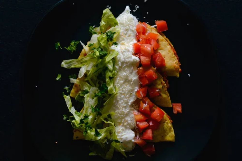 Mashed potato and chorizo fried tacos dorados with lettuce,