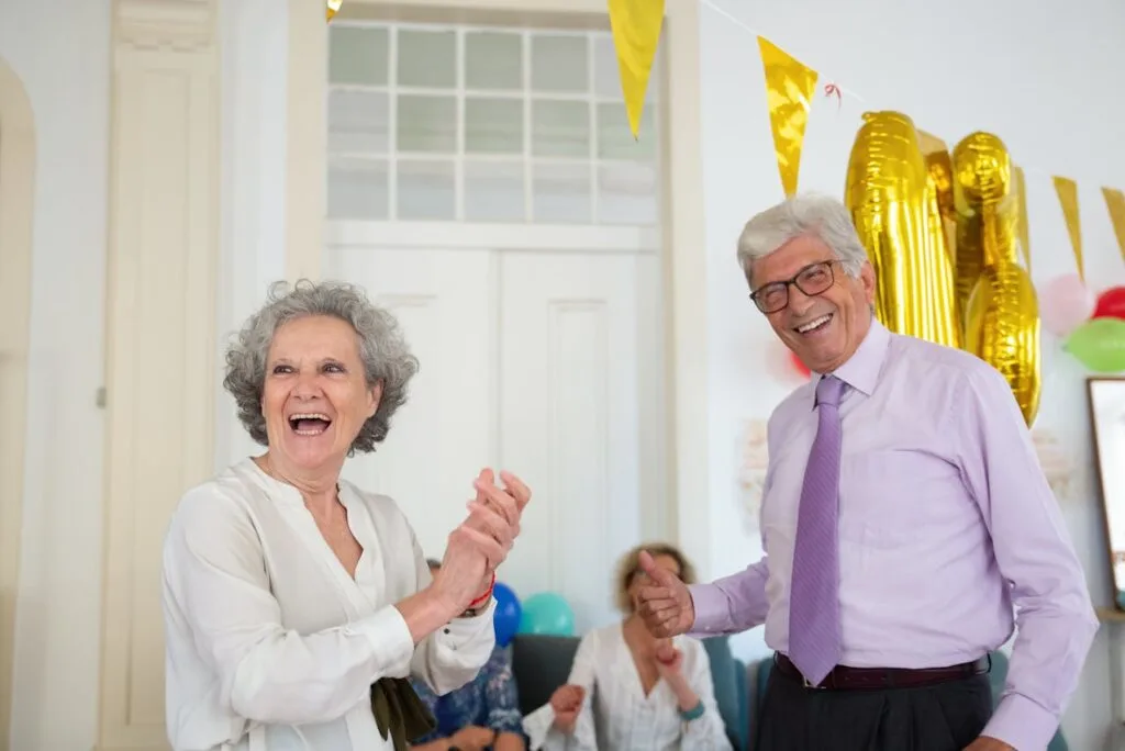 A man and woman celebrating his retirement at a party. Use these tips on funding your dream retirement lifestyle.