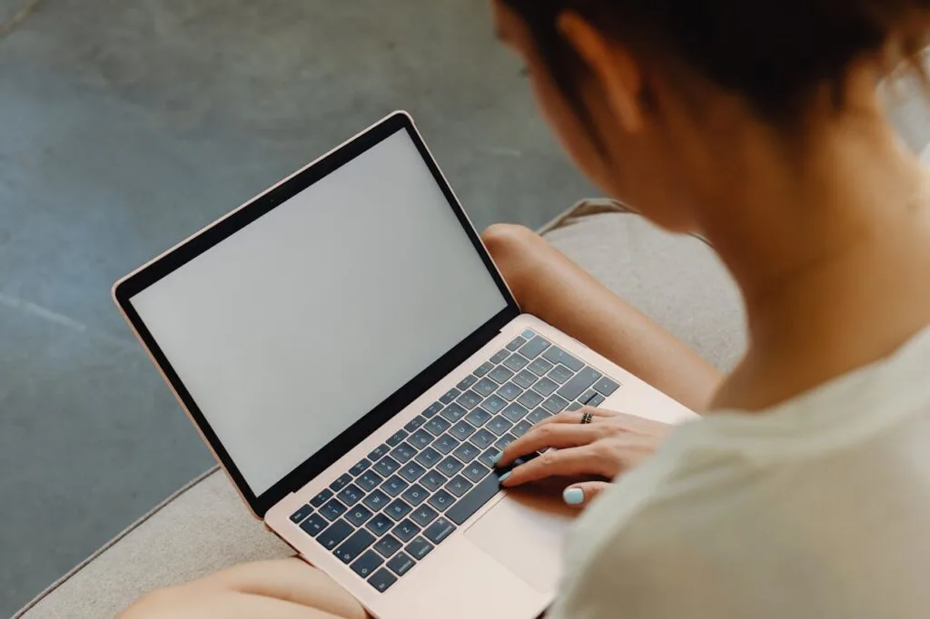 over-the-shoulder view of a person working on their laptop