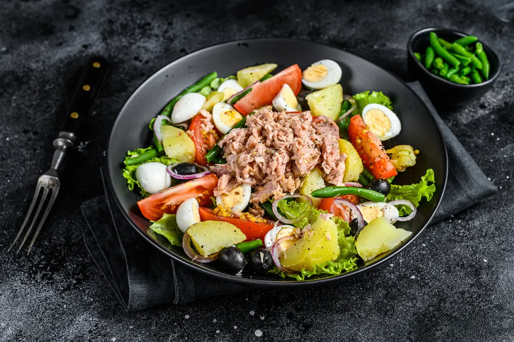 Tuna Salad Nicoise Vegetables Eggs Anchovies Plate Black Background Top — Stock Photo, Image