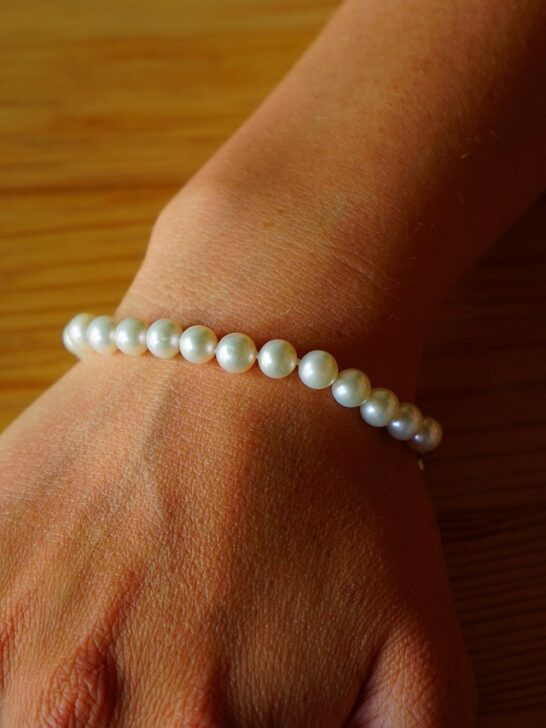 A lady wearing a pearl bracelet that are actually pearls on a budget she found