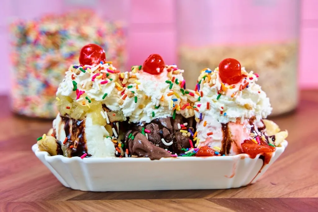 Close up picture of an ice cream sundae complete with whipped cream and sprinkles