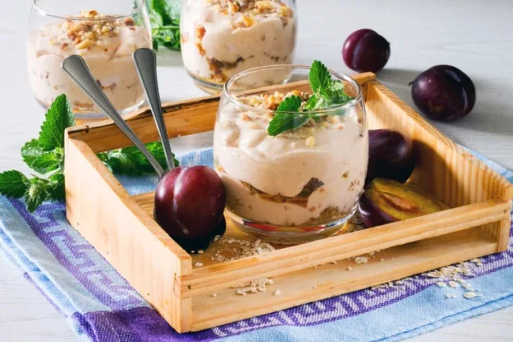 Dessert with whipped cream, roasted nuts oatmeal, prunes and wal — Stock Photo, Image