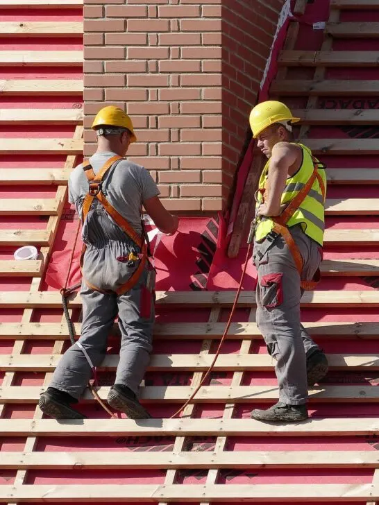 Two construction workers in appropriate clothing for their job, an example of how choosing the Right Workwear impacts safety and productivity