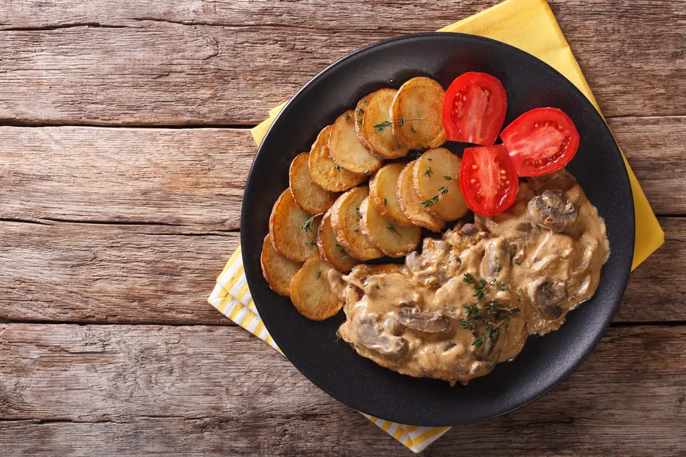 Diana steak garnished with fried potatoes close-up. Horizontal t — Stock Photo, Image