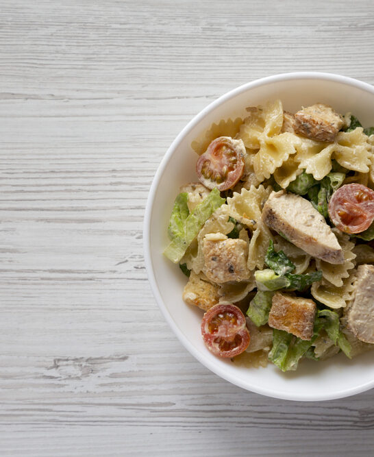 Homemade Chicken Caesar Pasta Salad White Bowl White Wooden Surface — Stock Photo, Image