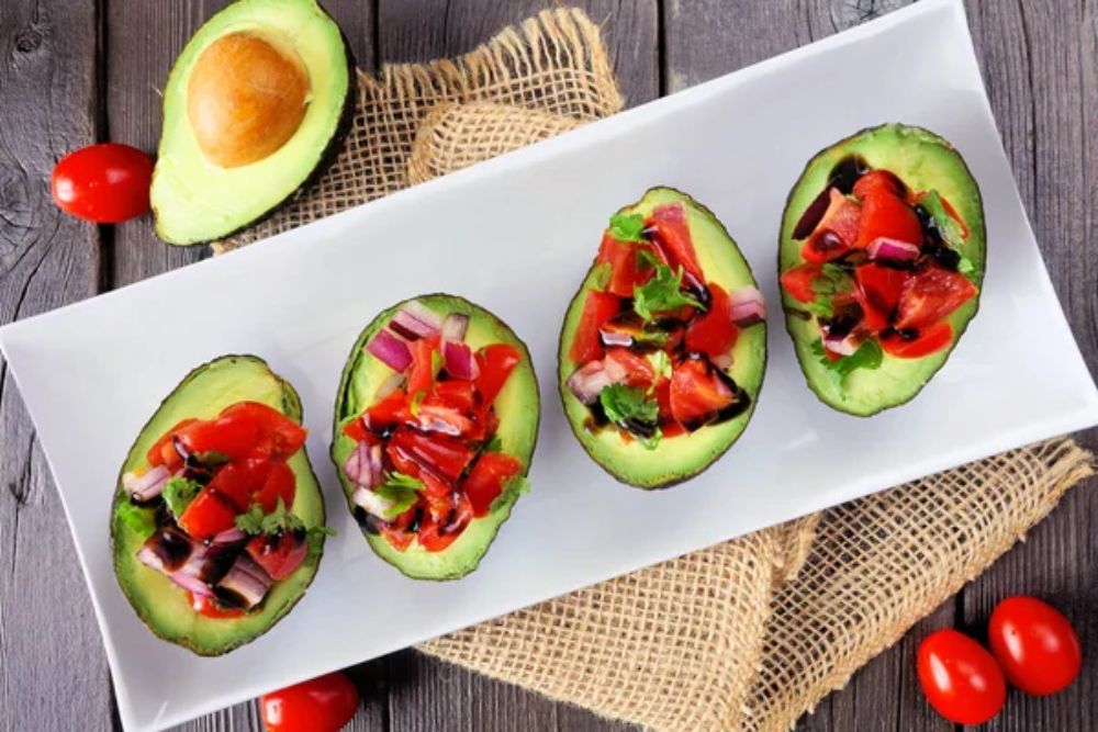 Healthy stuffed avocados with tomato bruschetta.