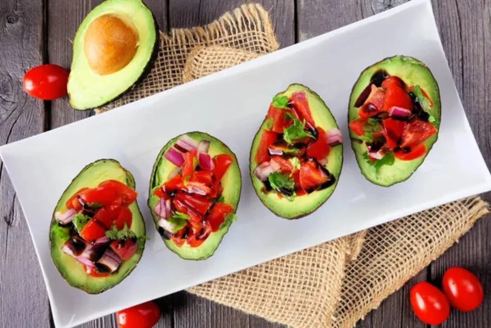 Healthy stuffed avocados with tomato bruschetta.