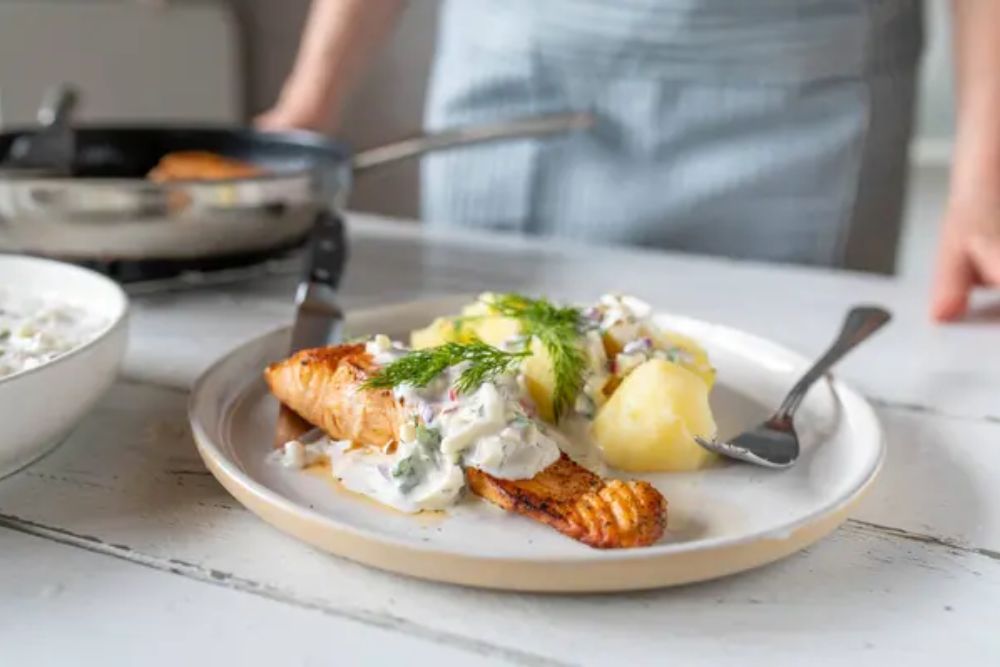 Pan fried salmon fillet with light yogurt apple dill sauce and boil