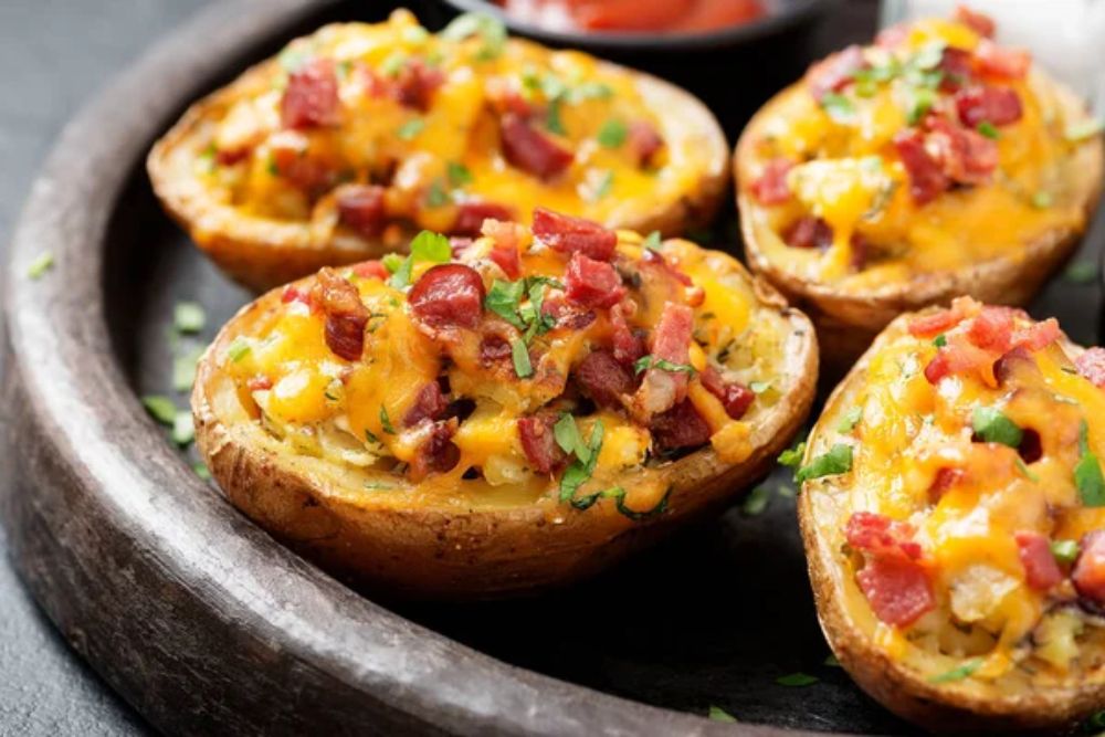 Hot baked potato topped with bacon, green onions and cheddar