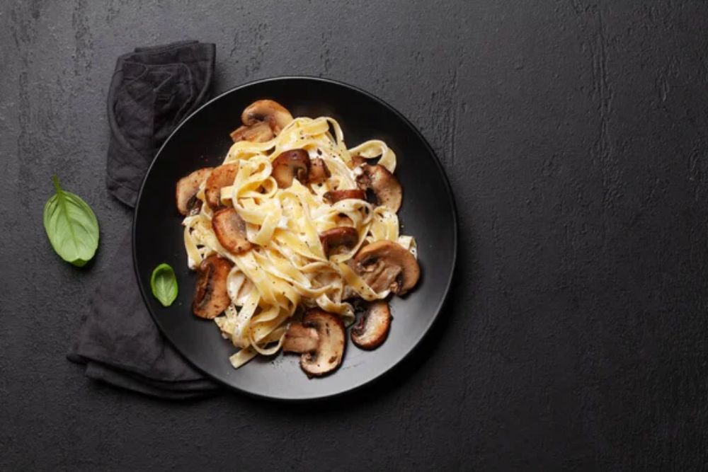 Various Italian pasta. Mushroom pasta with cream sauce.