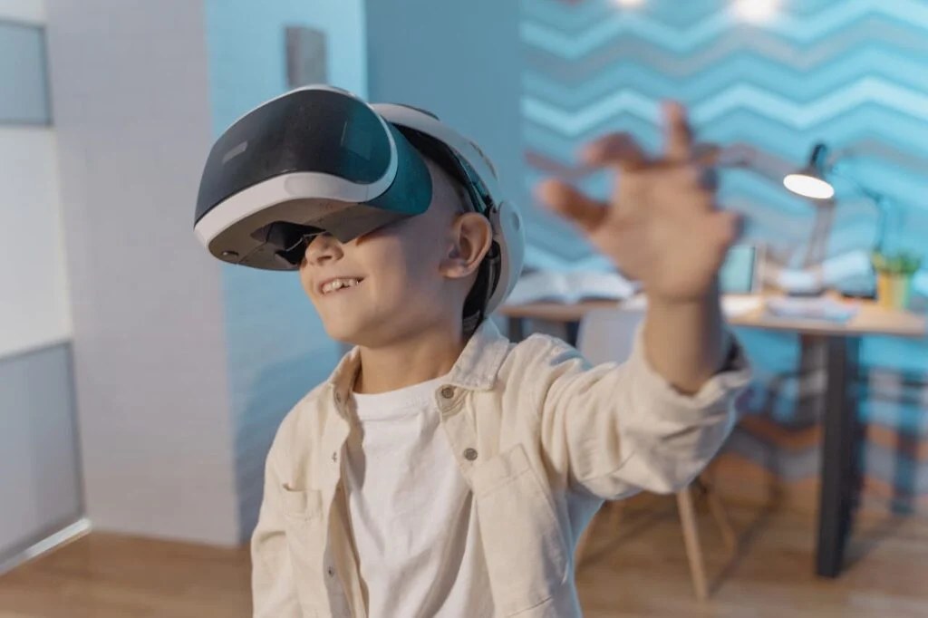A boy wearing VR goggles which are one of the modern educational tools for kids that form immersive learning.