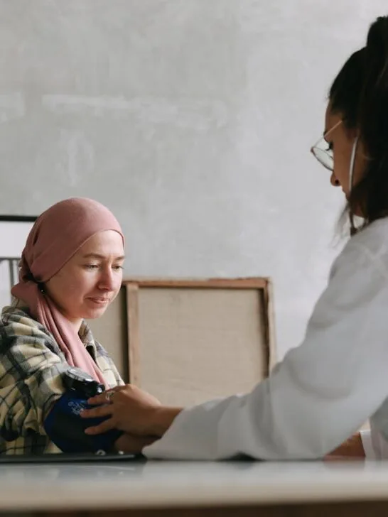 A doctor taking her patient's blood pressure. Learn why real-time medical updates could be a game-changer for cancer patients
