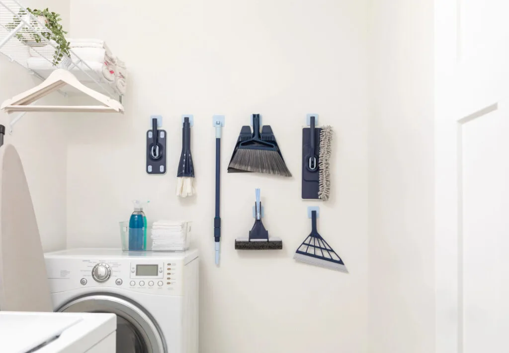 The full Casabella Click Clean and Organize collection hanging on the wall next to a washing machine